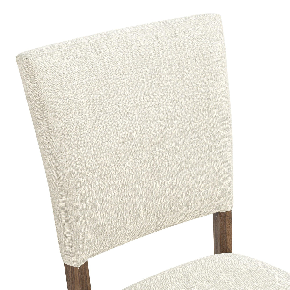 Close-up of a beige fabric upholstered dining chair with dark wood legs