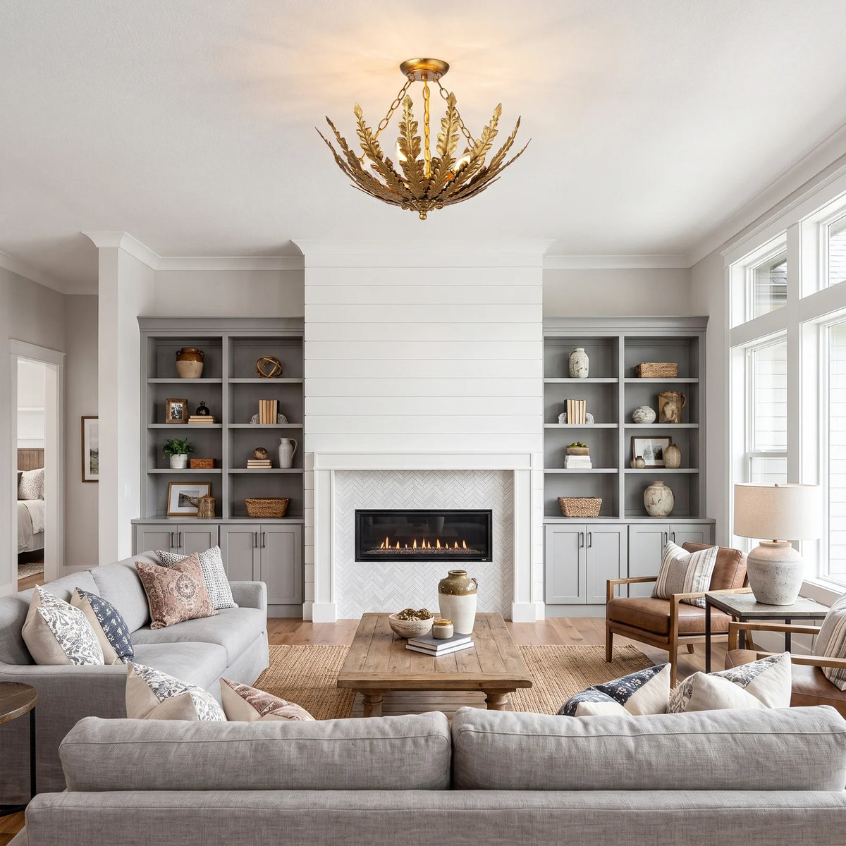 Gold leaf-style chandelier lighting fixture in a modern living room